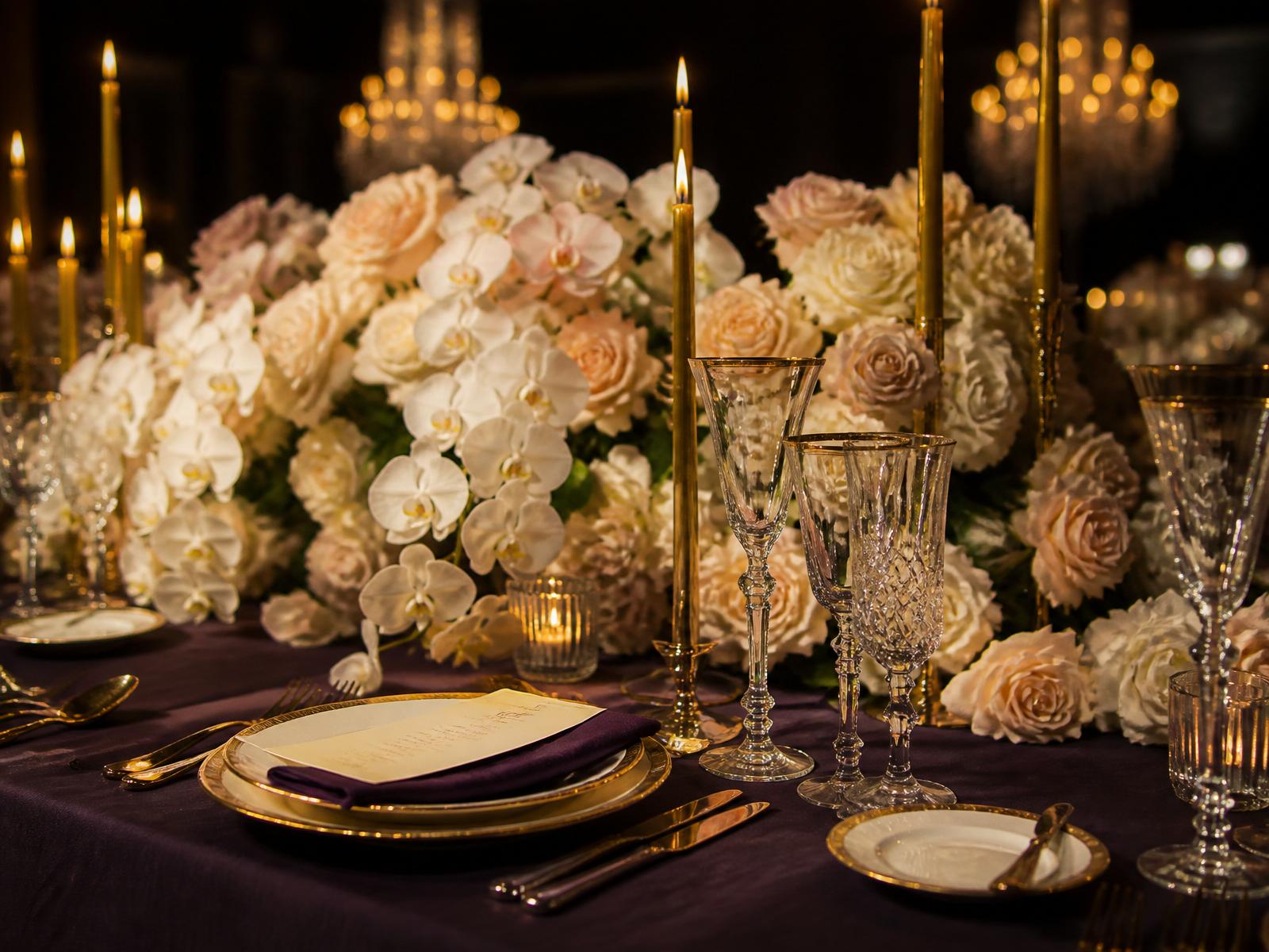An elegant candlelit banquet setting representing Adore's event design